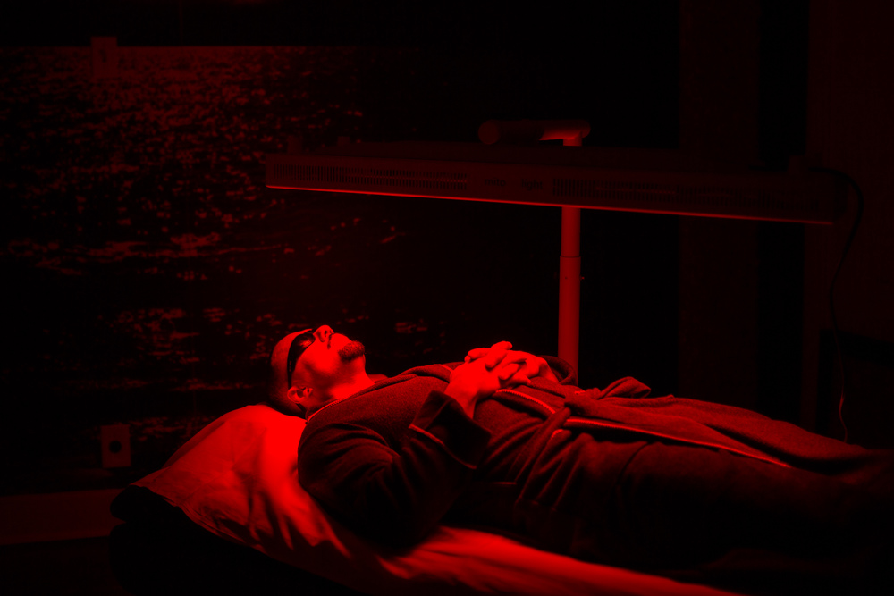 man laying using red light therapy at jardin's magical hands in sacramento, ca.