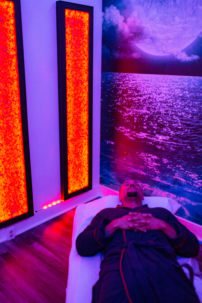 Man laying on recliner using red light therapy at Jardin's Magical Hands in Sacramento, CA.